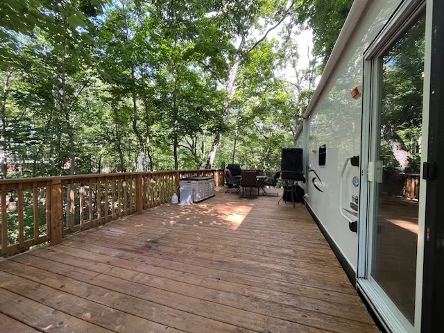 a kitchen with stainless steel appliances kitchen island granite countertop a dining table chairs refrigerator and sink