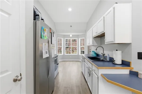 a kitchen with granite countertop a sink stove and cabinets