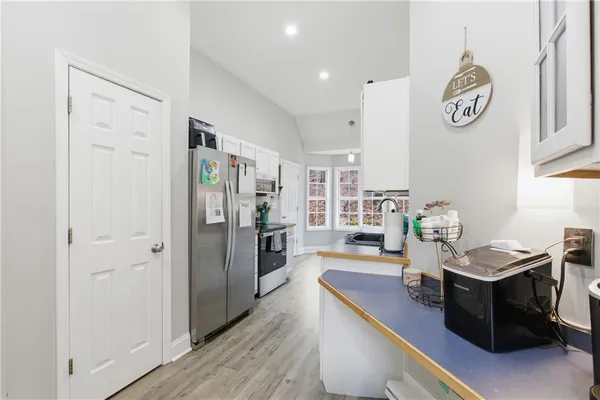 a kitchen with stainless steel appliances granite countertop a refrigerator and a stove top oven