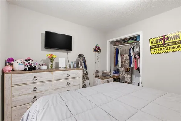 a bedroom with a bed and flat screen tv