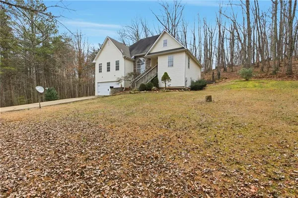 a view of an house with backyard and tree