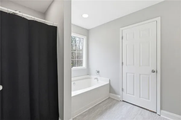 a bathroom with a bathtub and a shower