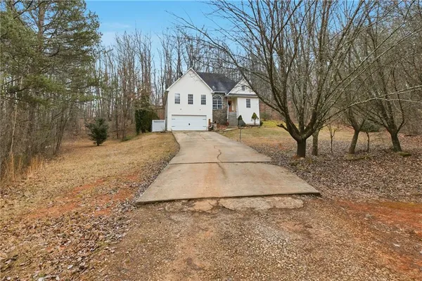 a view of white house with a yard