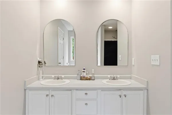 a bathroom with double sink and a mirror