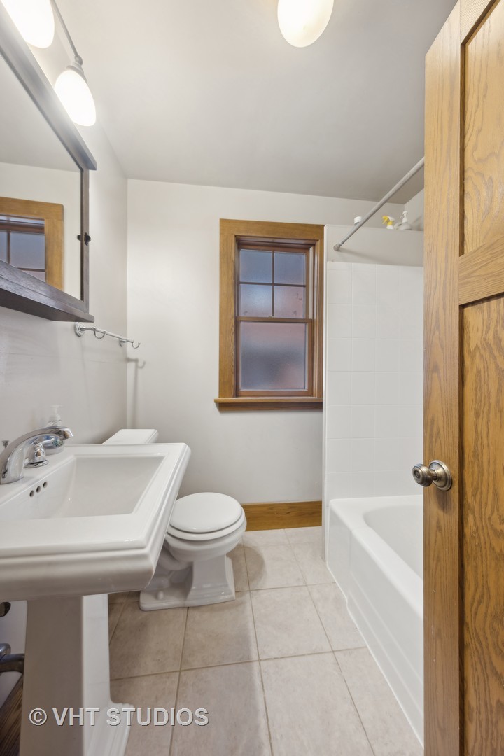 155 Geneva Avenue Elmhurst, IL 60126 - Photo 15 of 33 a bathroom with a sink toilet and shower
