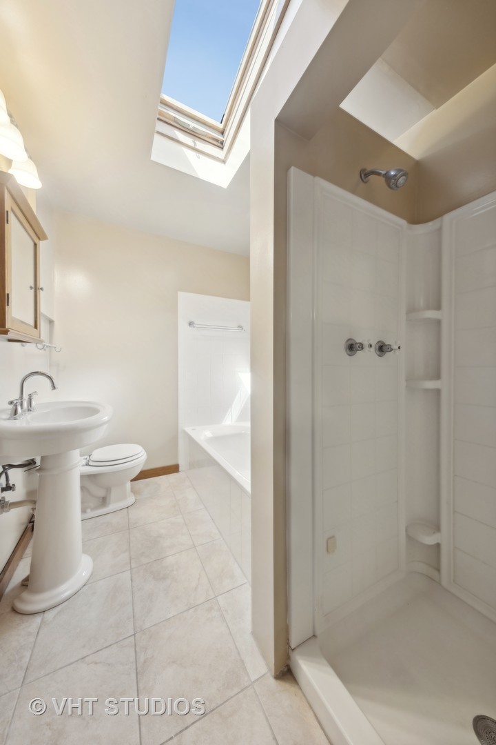 155 Geneva Avenue Elmhurst, IL 60126 - Photo 19 of 33 a bathroom with a toilet sink and shower