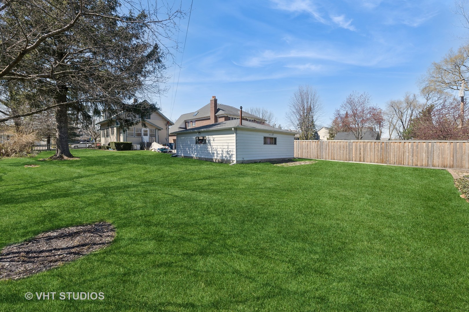 155 Geneva Avenue Elmhurst, IL 60126 - Photo 27 of 33 a view of a house with a big yard and large trees