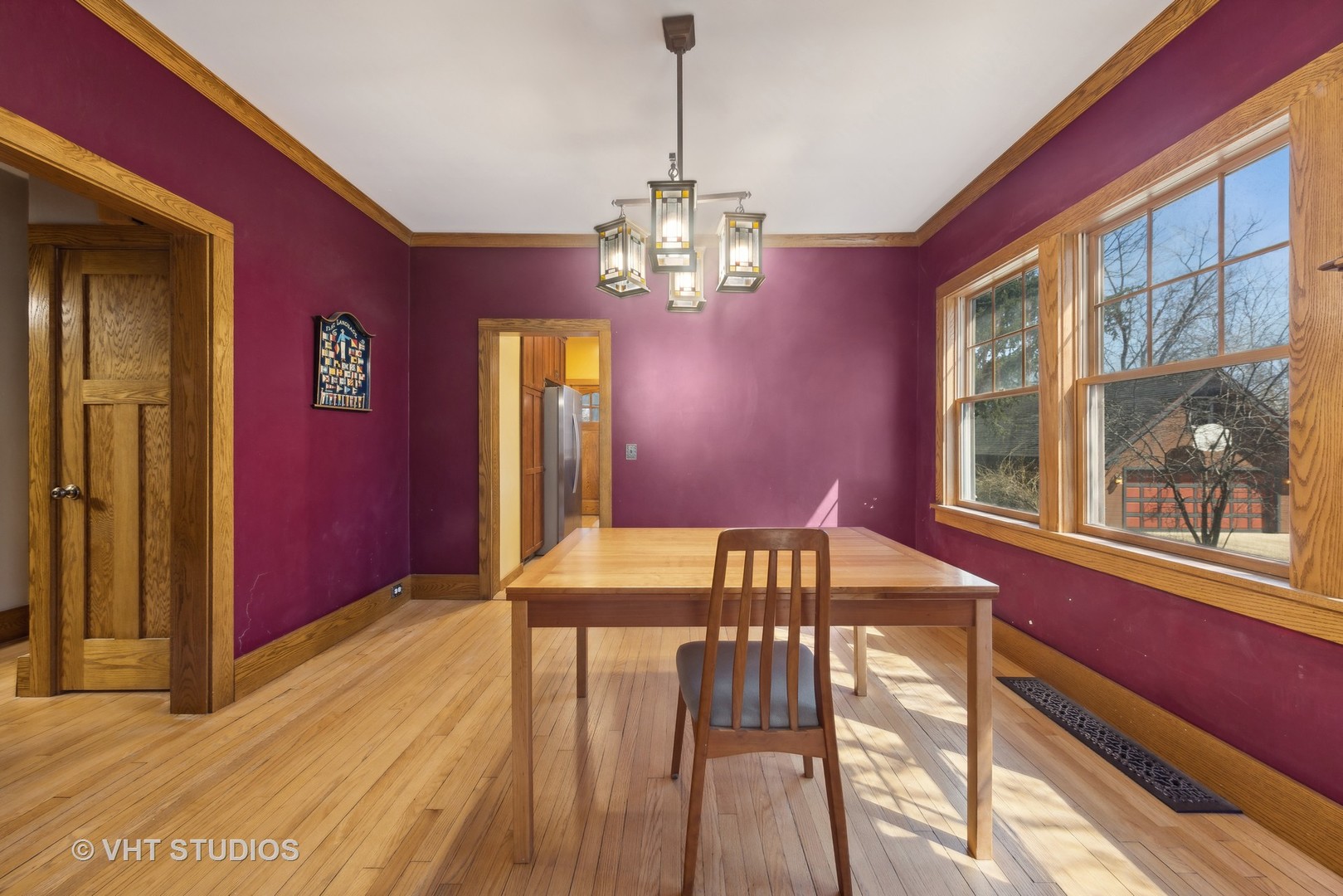 155 Geneva Avenue Elmhurst, IL 60126 - Photo 7 of 33 a view of a dining room with furniture a chandelier and wooden floor