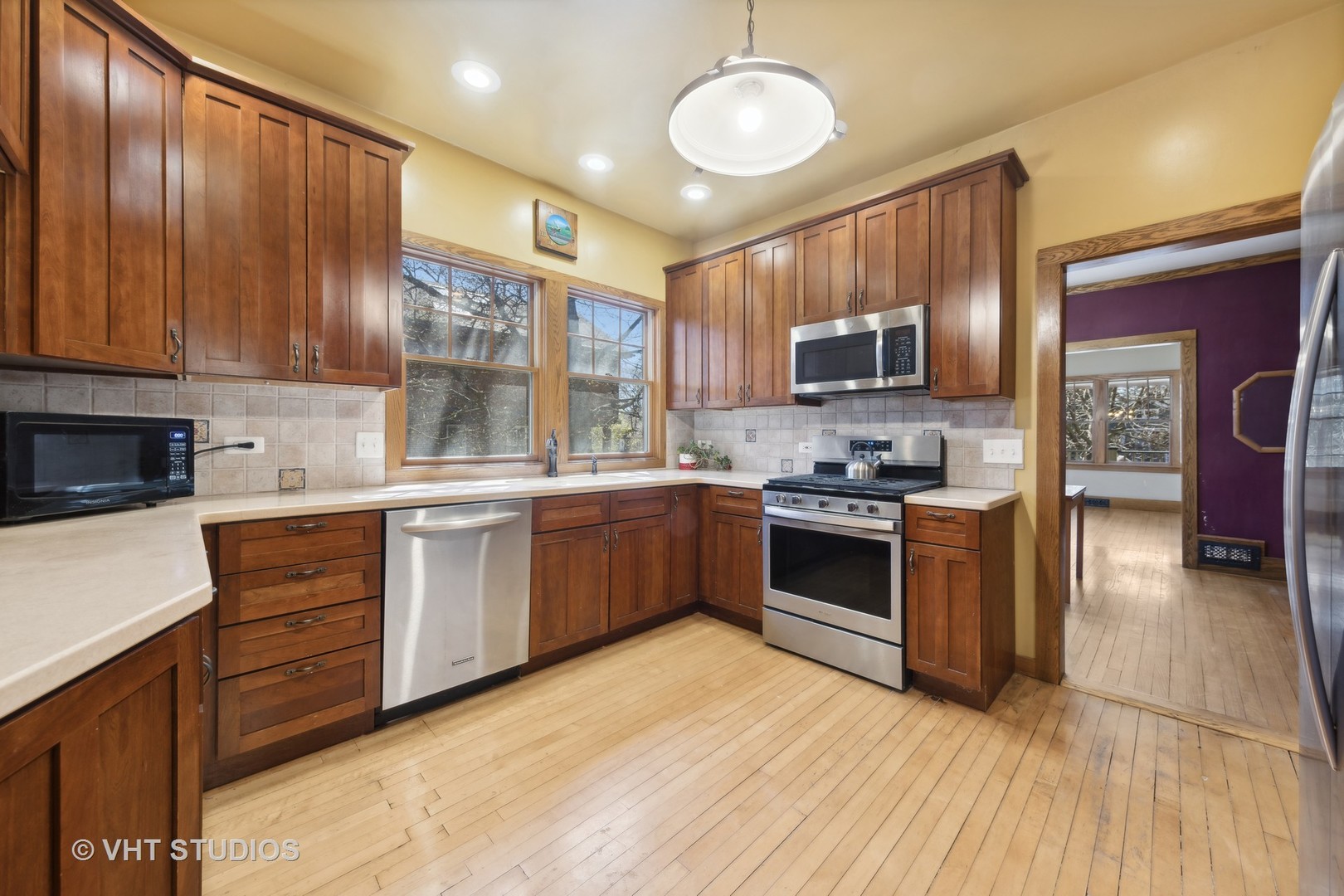 155 Geneva Avenue Elmhurst, IL 60126 - Photo 10 of 33 a kitchen with stainless steel appliances a stove top oven a sink dishwasher a refrigerator and a oven with wooden floor