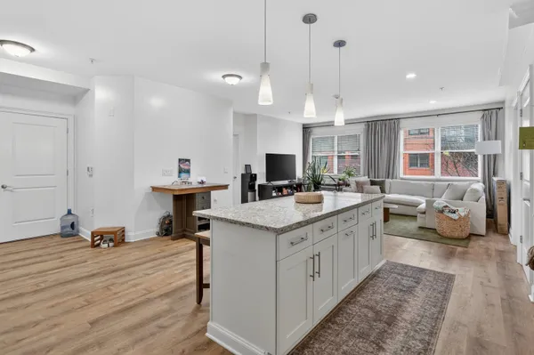 a kitchen with a sink stove and cabinets