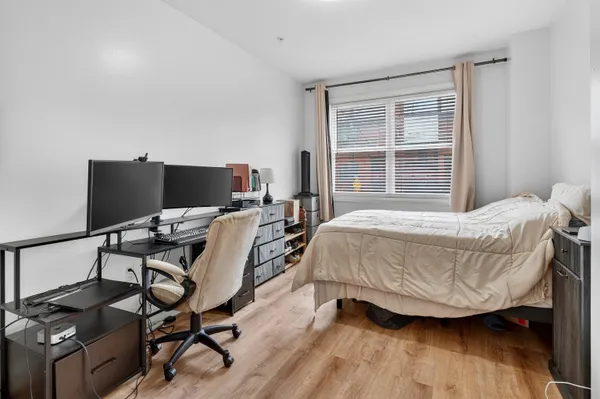 a bedroom with a bed and wooden floor
