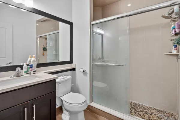 a bathroom with a sink a toilet and shower