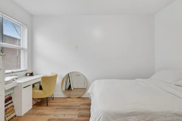 a bedroom with a bed a table and chair