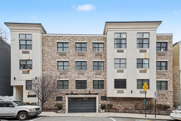 a front view of a building with parking space