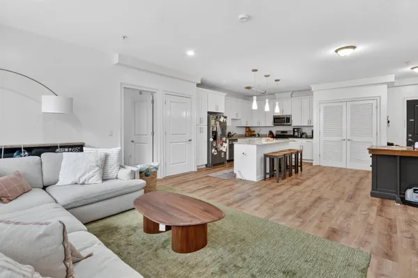 a living room with stainless steel appliances kitchen island granite countertop furniture and a kitchen view