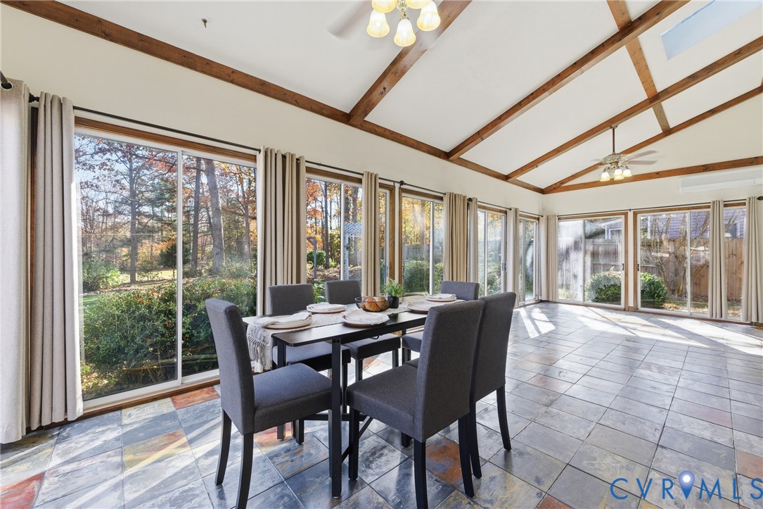 7471 Shoreline Drive Quinton, VA 23141 - Photo 16 of 45 a dining room with furniture large windows and wooden floor