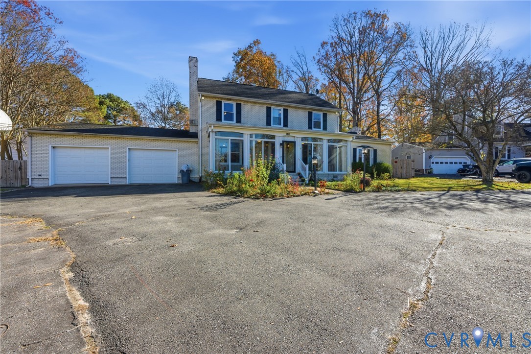 7471 Shoreline Drive Quinton, VA 23141 - Photo 3 of 45 a front view of a house with a yard and trees