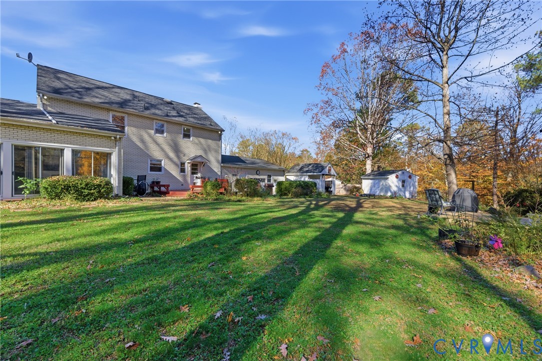 7471 Shoreline Drive Quinton, VA 23141 - Photo 32 of 45 a view of a house with a big yard and large trees