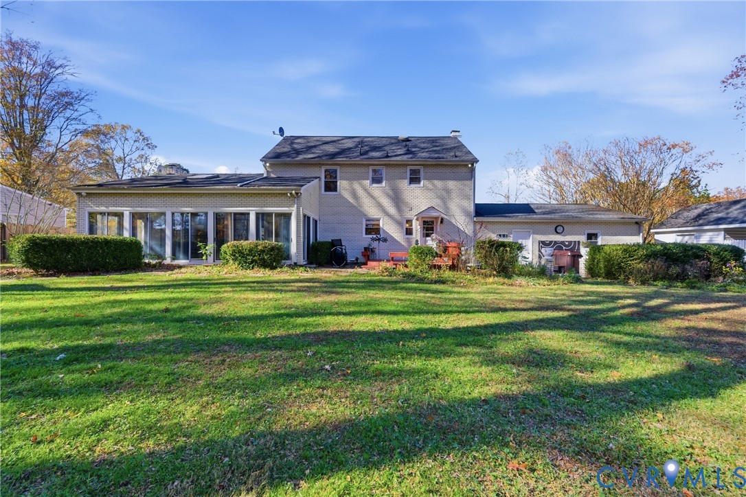 7471 Shoreline Drive Quinton, VA 23141 - Photo 33 of 45 a front view of a house with a garden and trees