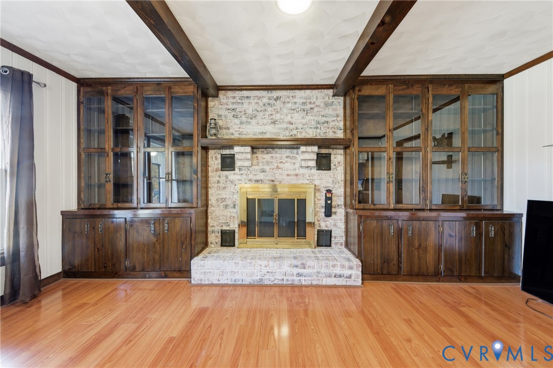 7471 Shoreline Drive Quinton, VA 23141 - Photo 8 of 45 an empty room with wooden floor and a fireplace