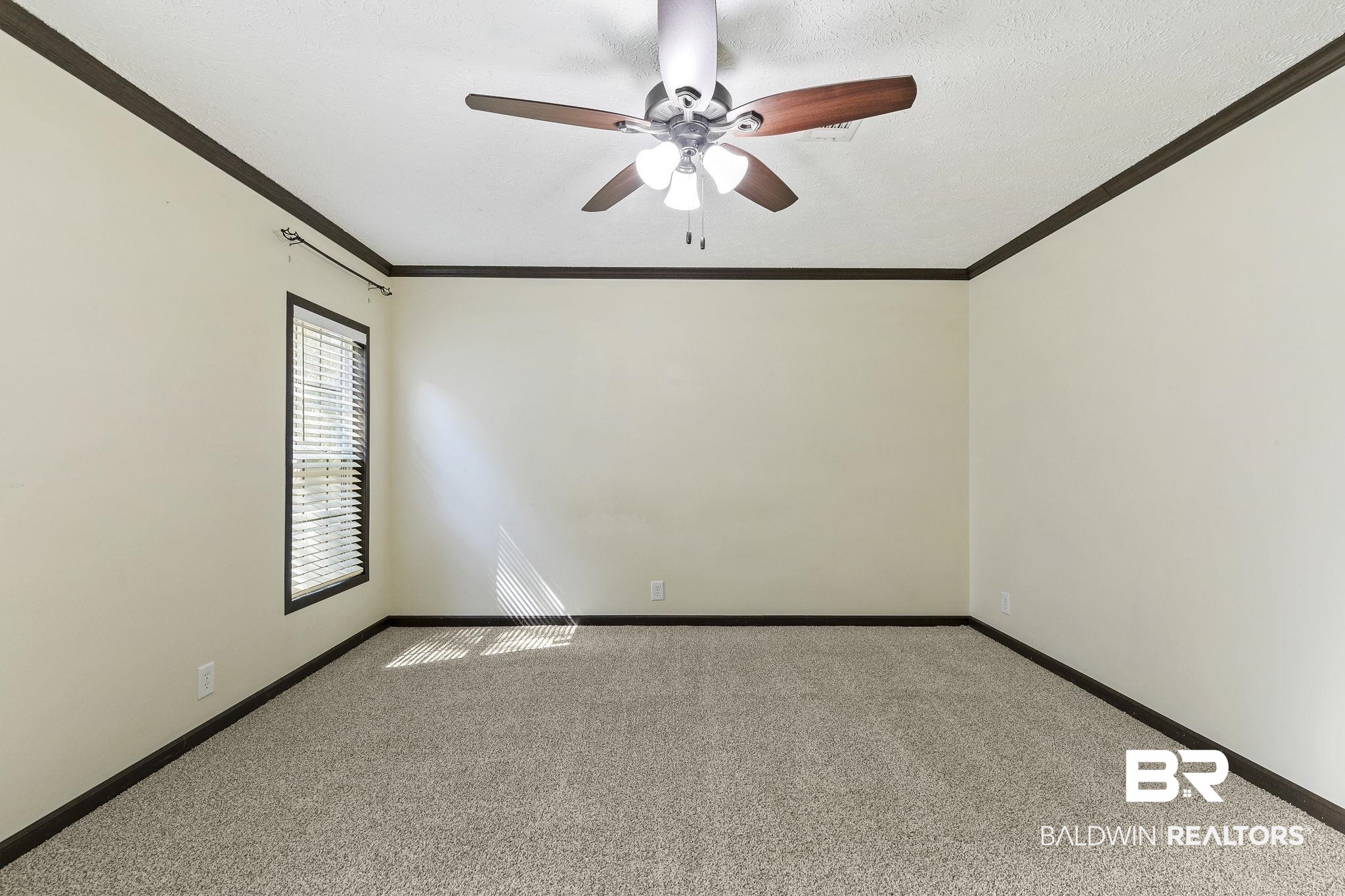35641 County Road 39 Stapleton, AL 36578 - Photo 32 of 46 Unfurnished room with a textured ceiling, crown molding, light carpet, and ceiling fan