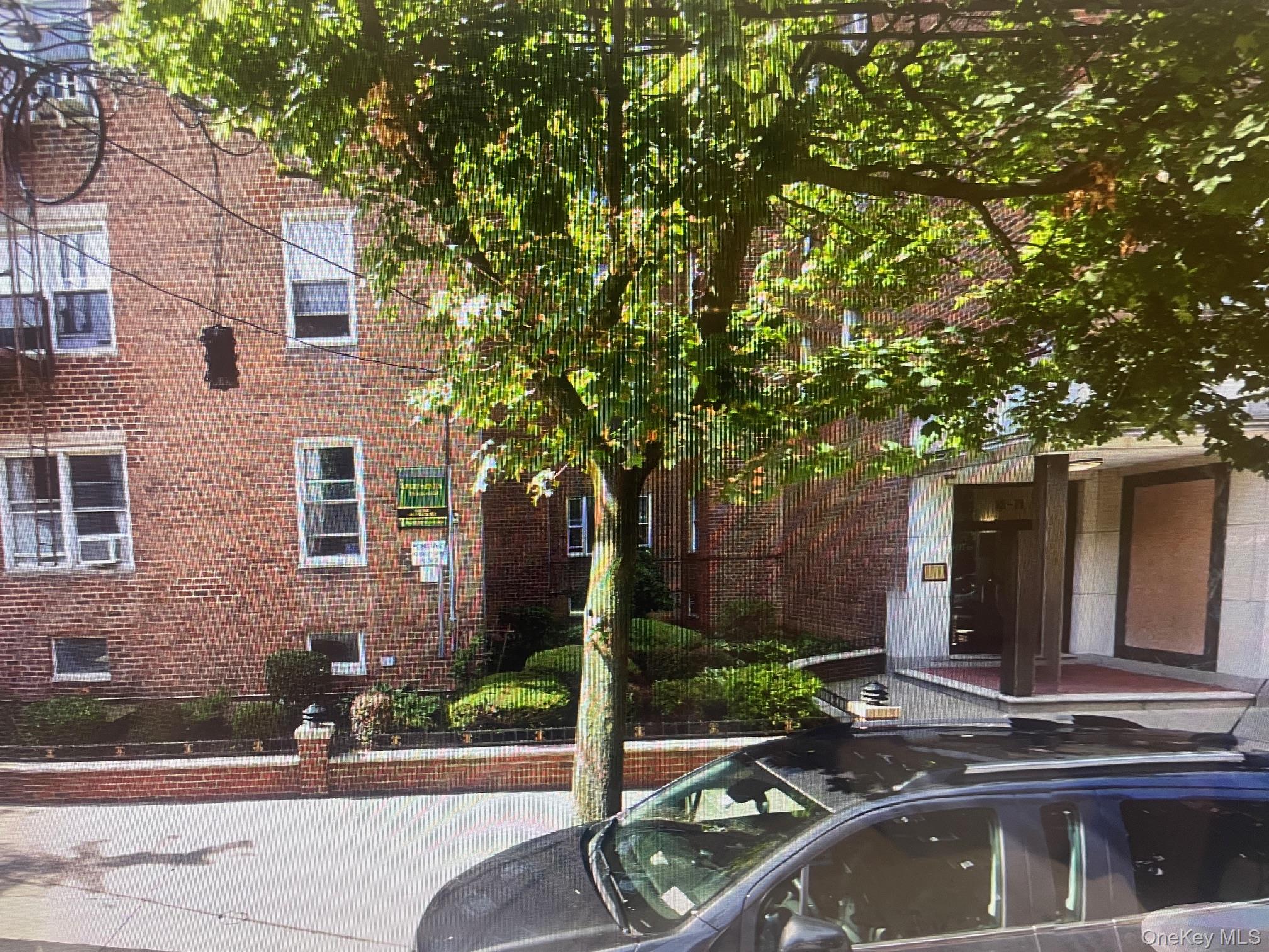 65-70 Booth Street, Unit 2B Queens, NY 11374 - Photo 1 of 8 a view of house with a swimming pool