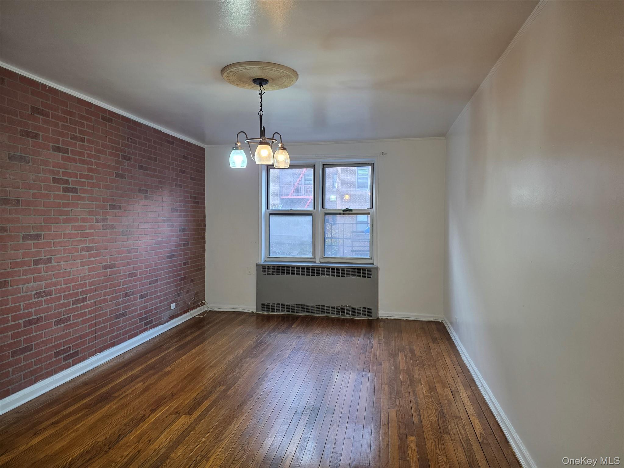 65-70 Booth Street, Unit 2B Queens, NY 11374 - Photo 2 of 8 a view of empty room with wooden floor and fan