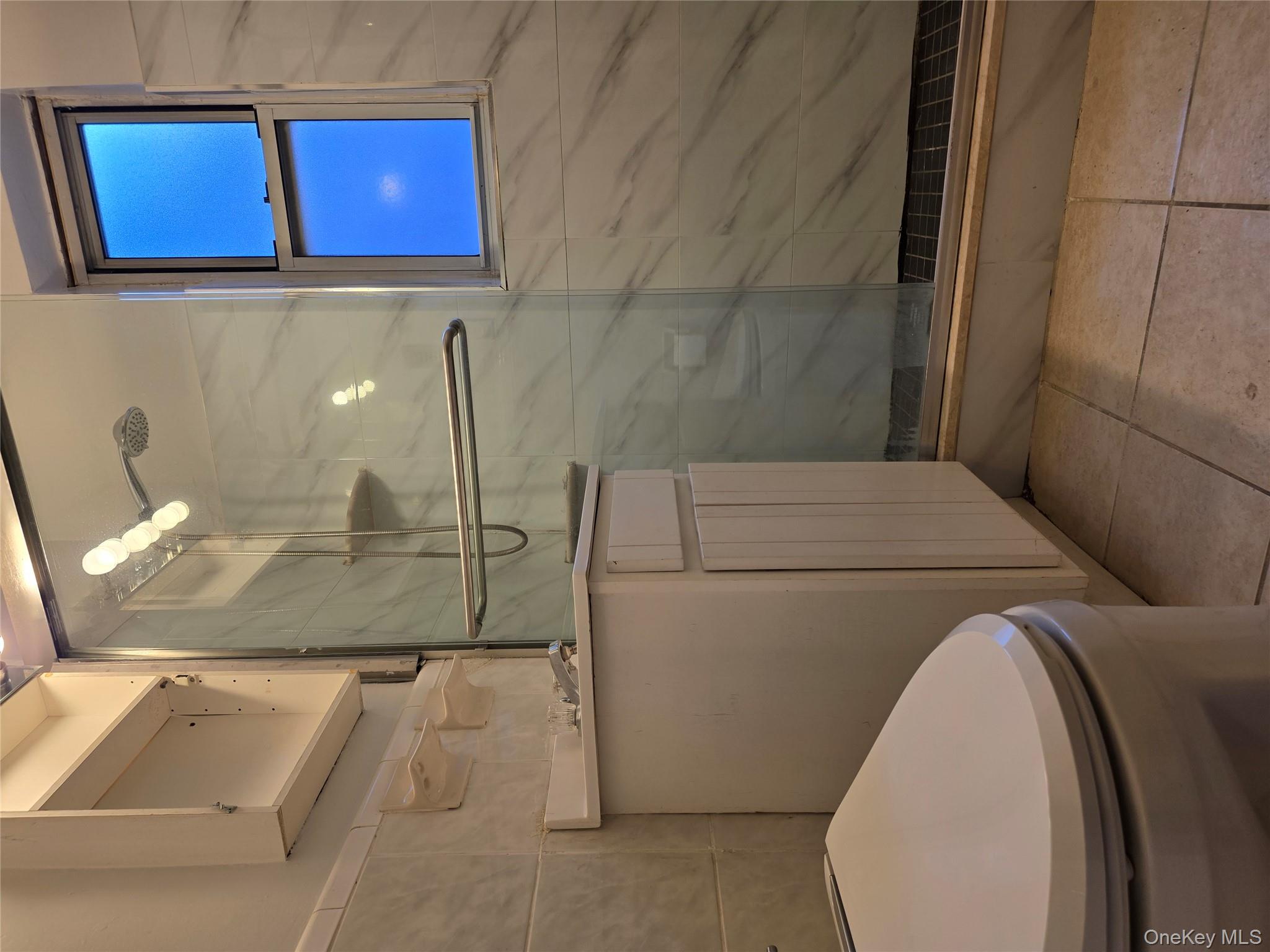 65-70 Booth Street, Unit 2B Queens, NY 11374 - Photo 6 of 8 a bathroom with a toilet and a shower