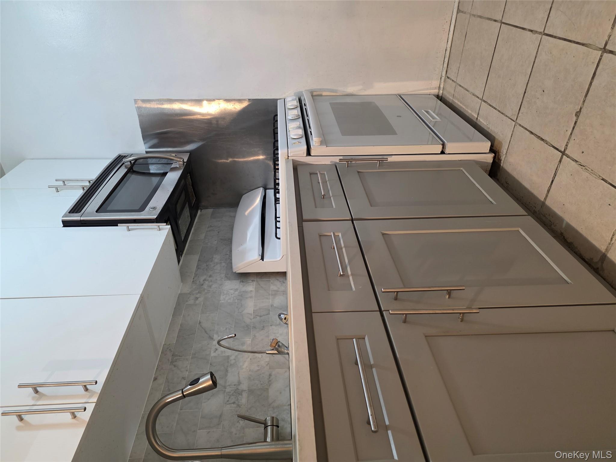 65-70 Booth Street, Unit 2B Queens, NY 11374 - Photo 8 of 8 a kitchen with cabinets and appliances