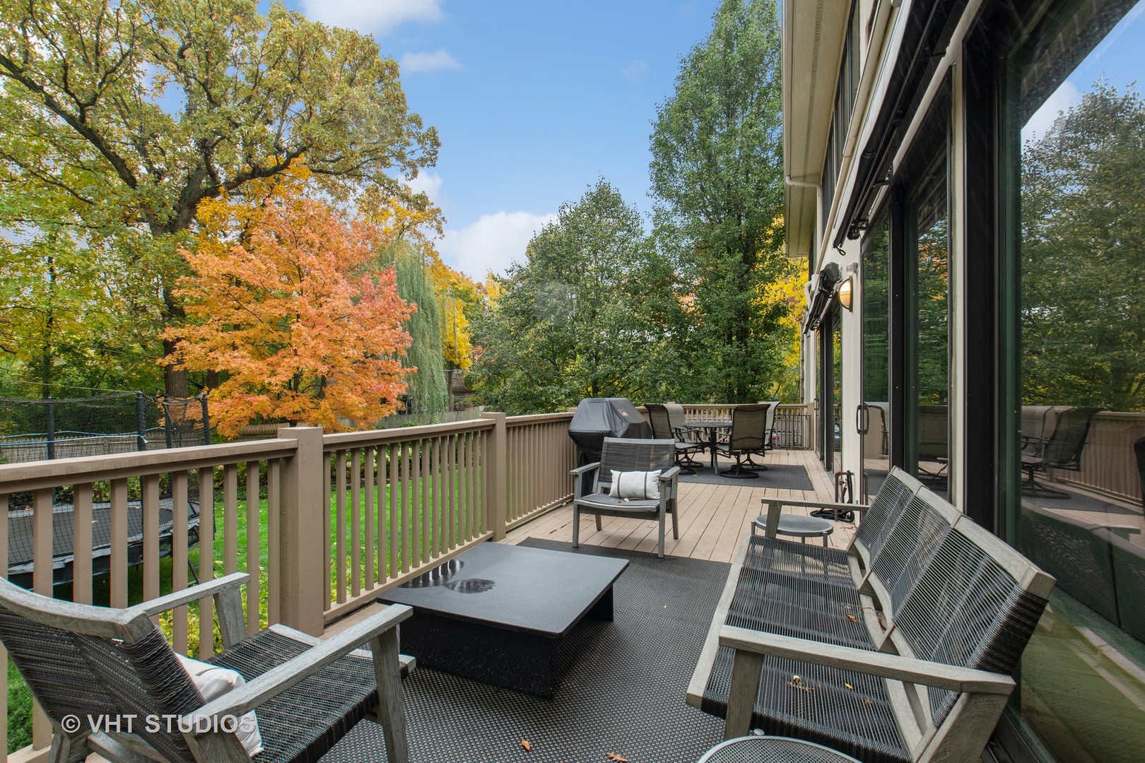 Undisclosed Address Highland Park, IL 60035 - Photo 27 of 32 a view of a patio with couches table and chairs and potted plants with wooden floor and fence