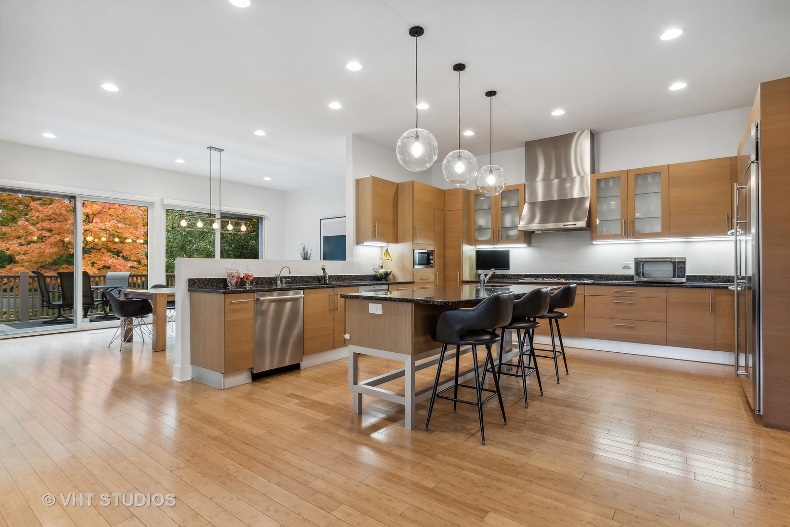 Undisclosed Address Highland Park, IL 60035 - Photo 6 of 32 a kitchen with a table chairs wooden floor and a view of living room