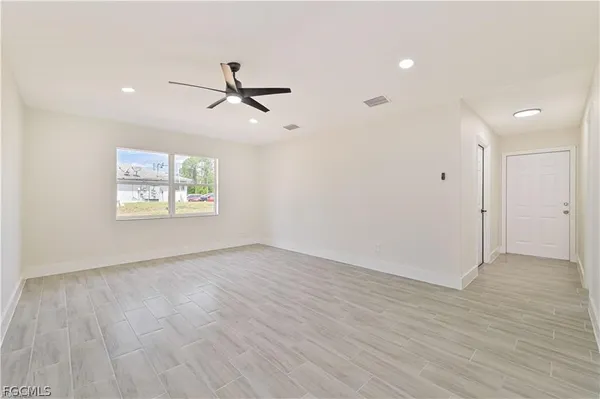 wooden floor in an empty room with a window
