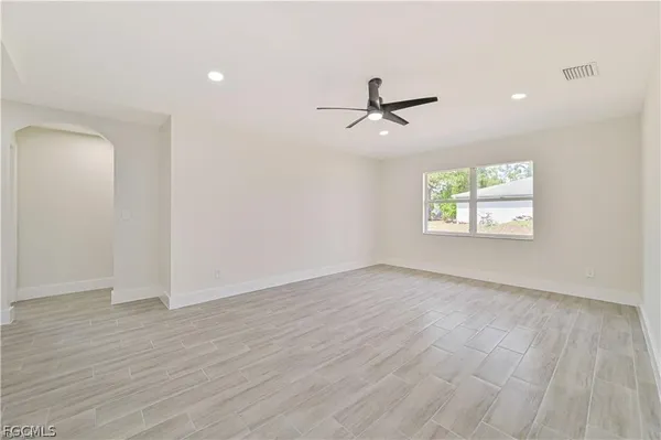wooden floor in an empty room with a window