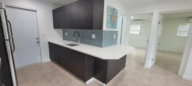 a bathroom with a sink a mirror and a shower