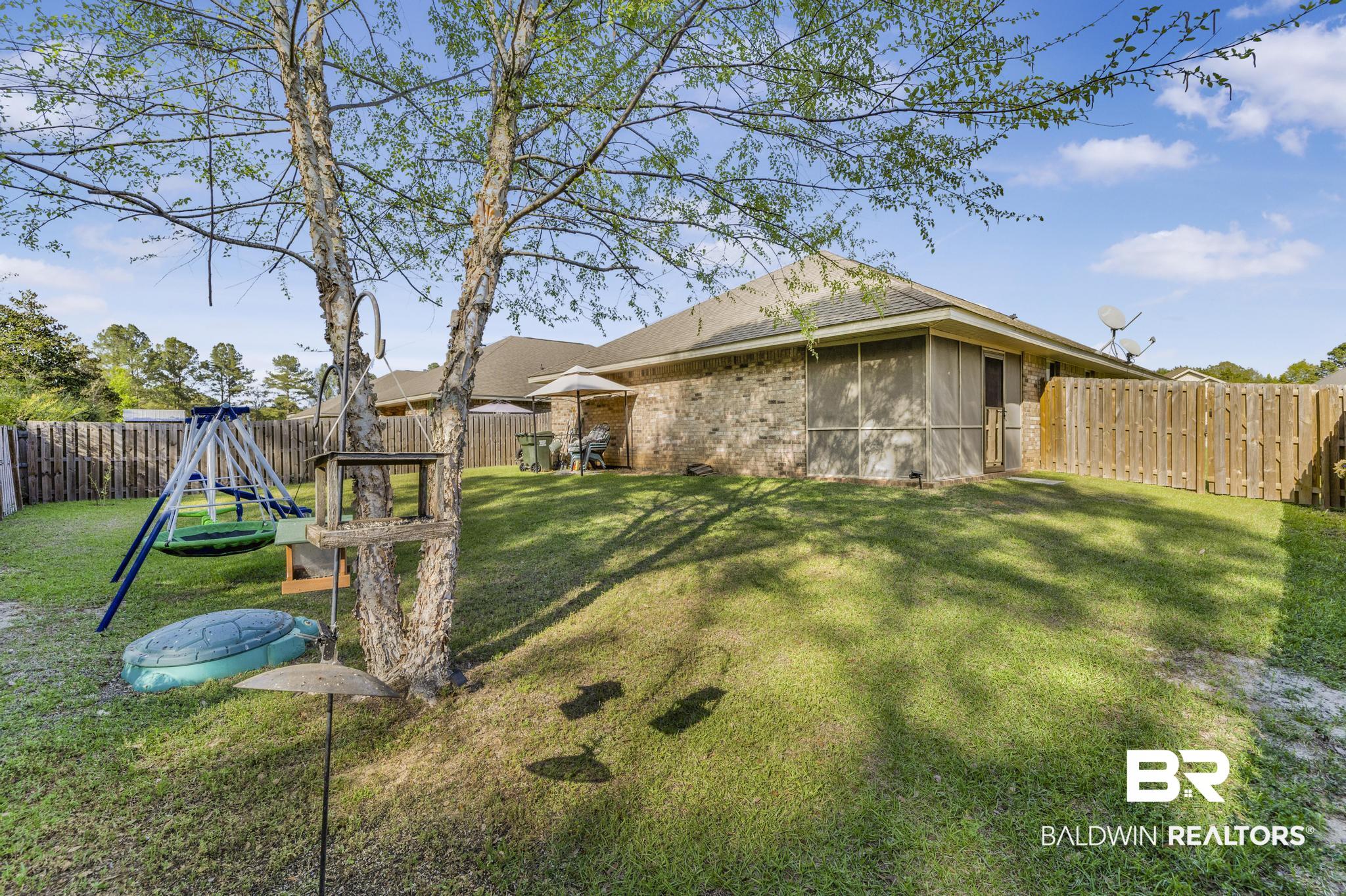 22043 Garland Loop Silverhill, AL 36576 - Photo 33 of 41 Fenced backyard with a patio area