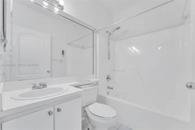 a bathroom with a sink toilet vanity and shower
