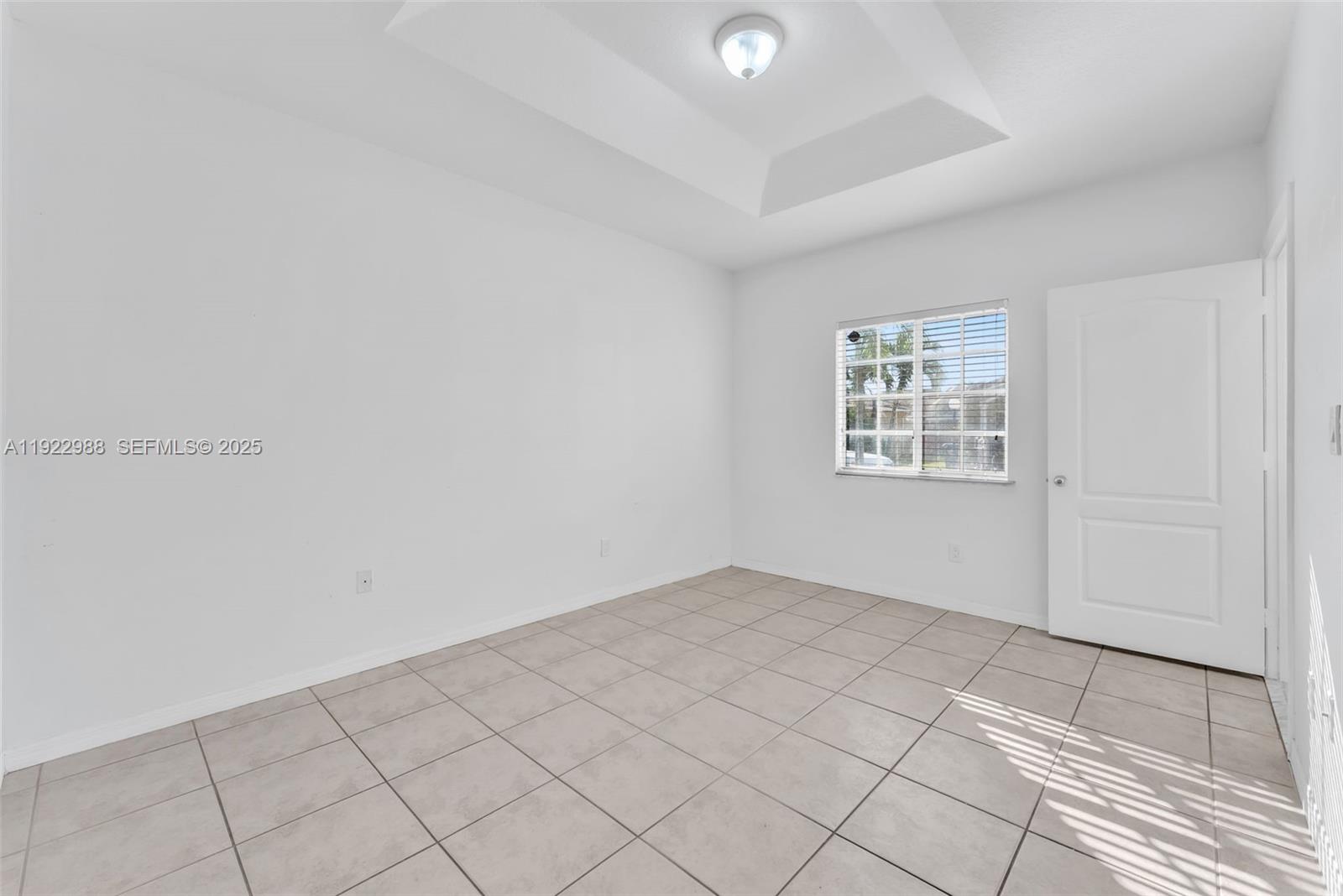 7665 Northwest 183rd Terrace, Unit 1405 Hialeah, FL 33015 - Photo 13 of 26 an empty room with windows