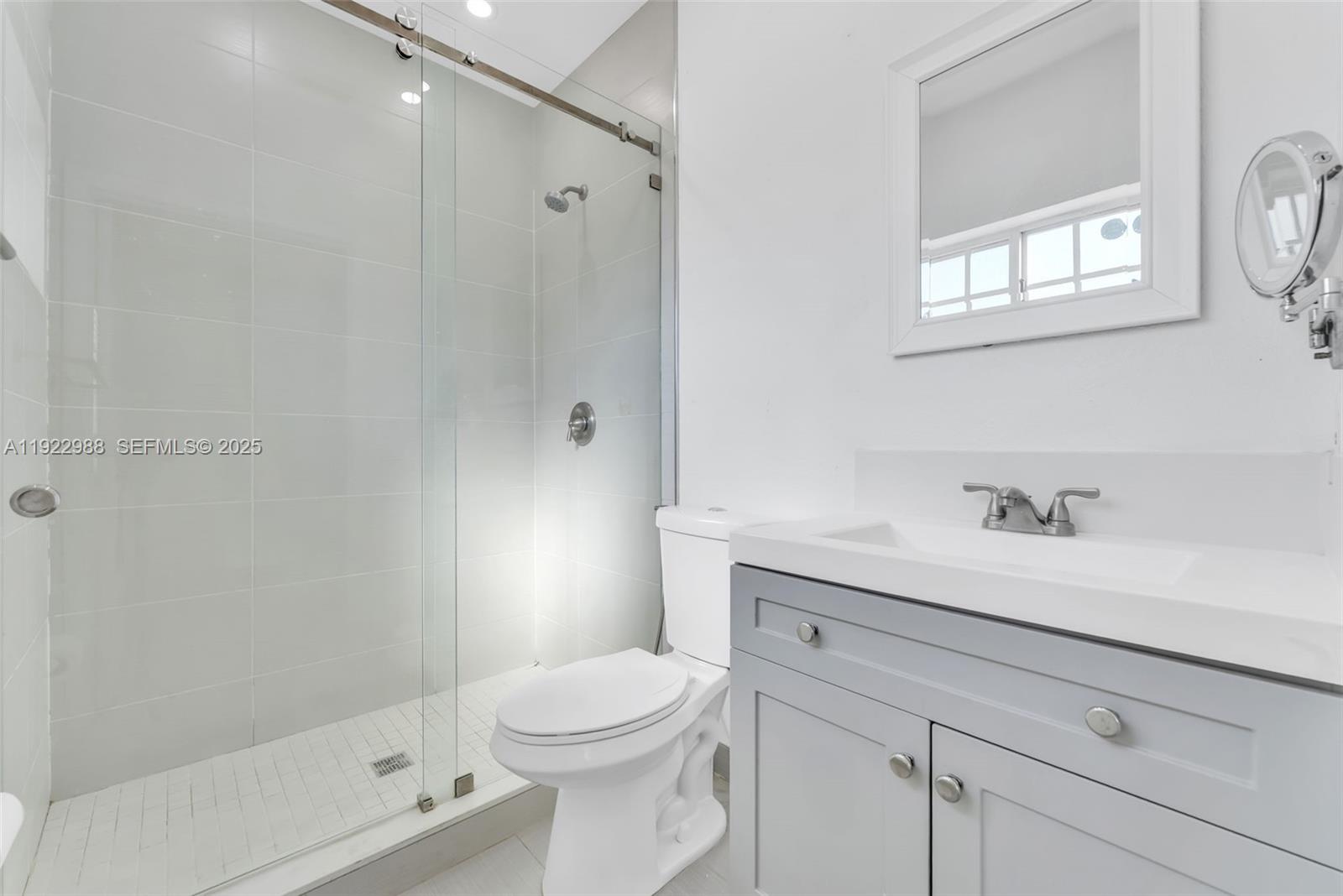 7665 Northwest 183rd Terrace, Unit 1405 Hialeah, FL 33015 - Photo 16 of 26 a bathroom with a sink a toilet and shower
