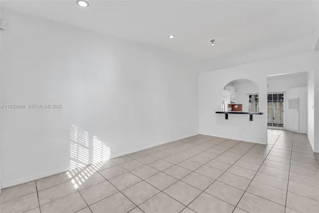 a view of a kitchen with furniture and an empty room