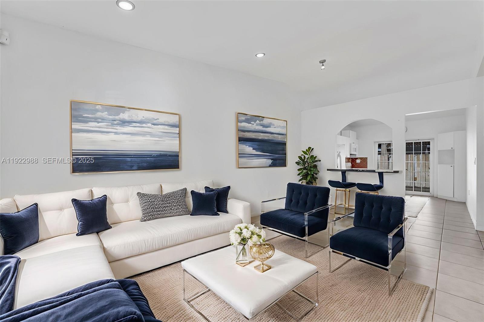 7665 Northwest 183rd Terrace, Unit 1405 Hialeah, FL 33015 - Photo 3 of 26 a living room with furniture and a wooden floor