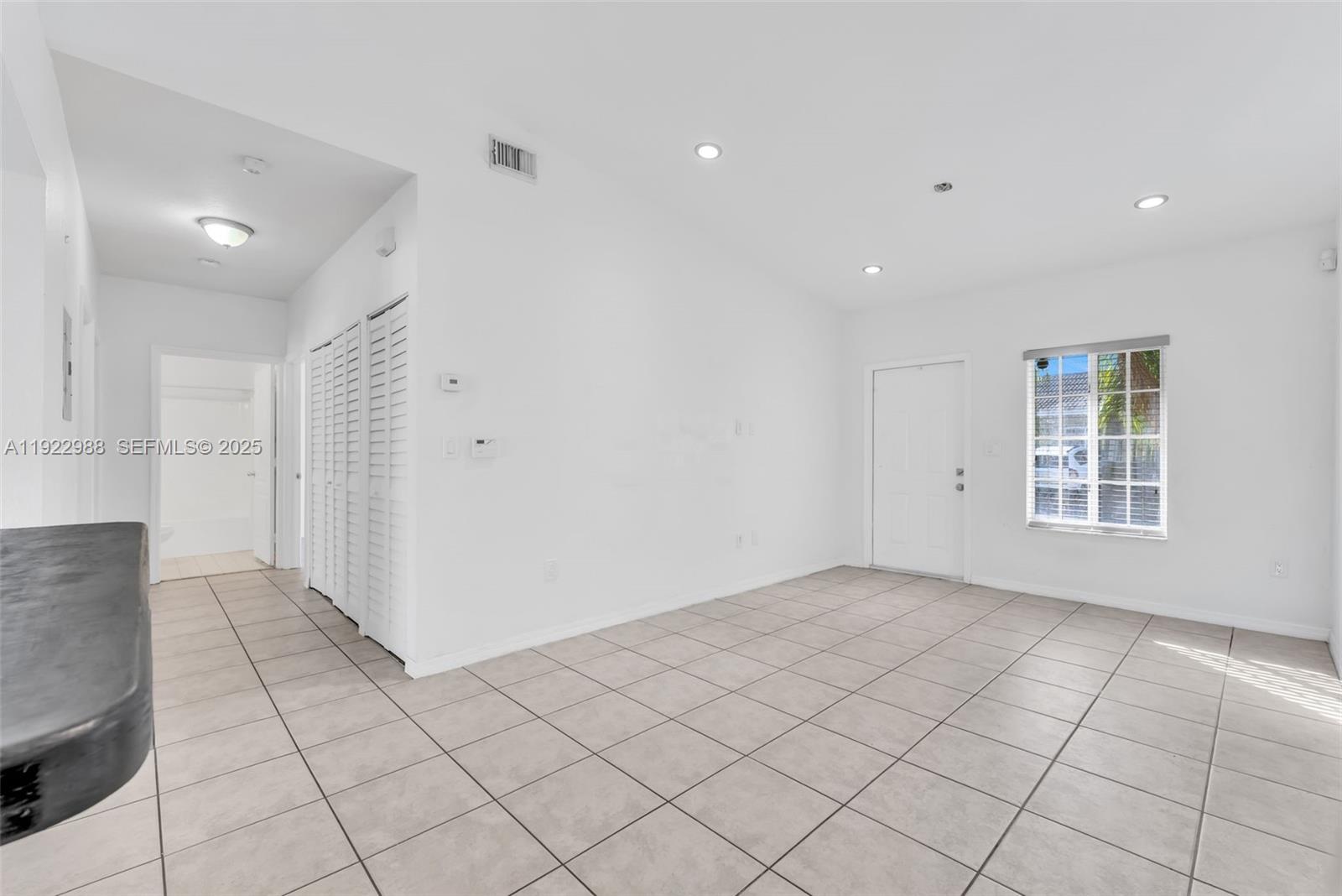 7665 Northwest 183rd Terrace, Unit 1405 Hialeah, FL 33015 - Photo 4 of 26 an empty room with windows