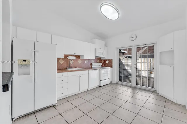 a kitchen with cabinets and window