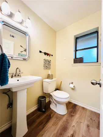 a bathroom with a sink toilet and mirror