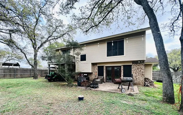 a view of a house with a yard and tree