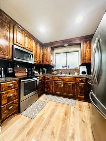 a kitchen with stainless steel appliances a stove sink and cabinets