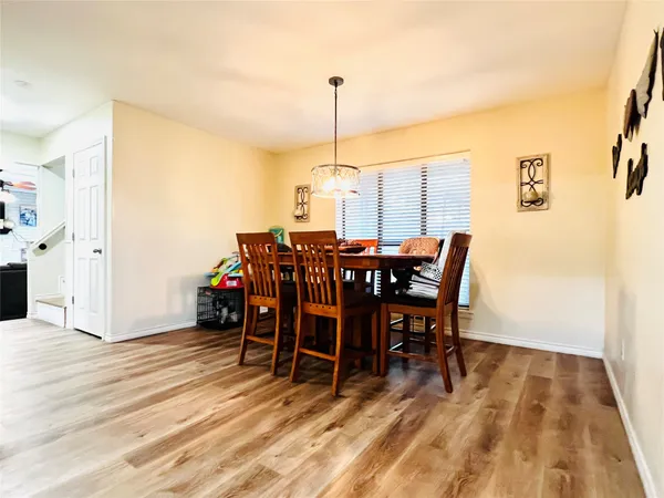 a dining room with furniture and wooden floor