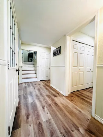 an empty room with wooden floor and white walls
