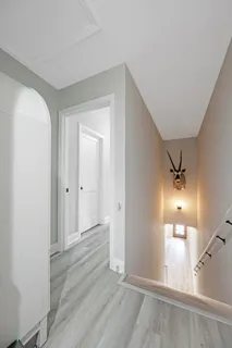 a bedroom with a bed windows and a ceiling fan