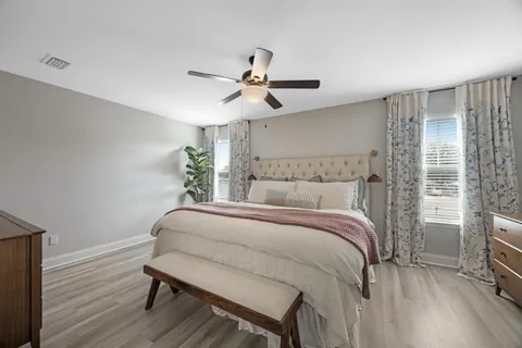 a bed room with a bed and a chandelier