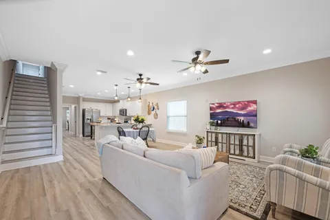 a living room with furniture and a wooden floor